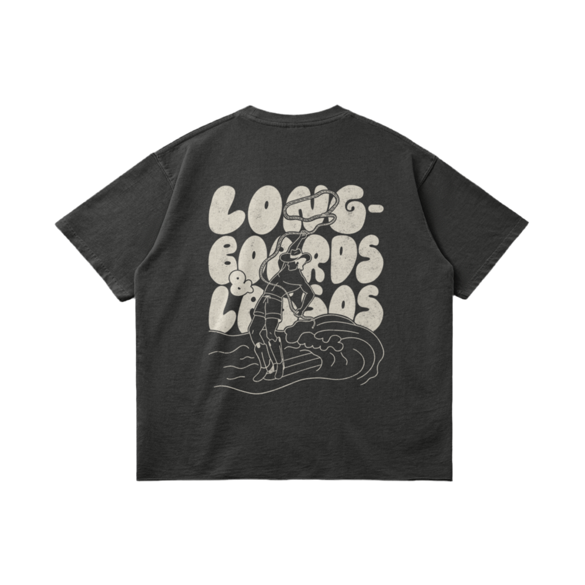 Back of a dark grey t-shirt with a white picture of a male surfer wearing cowboy boots and holding a lasso riding a wave on a longboard with the bubble writing saying, 'Longboards & Lassos' in the background.